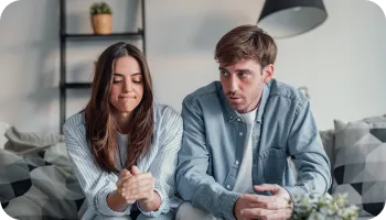 Couple experiencing relationship stress during emotional conversation at home