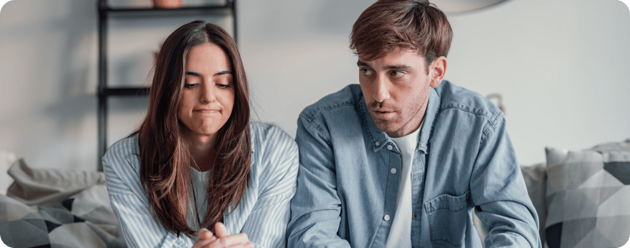 Couple experiencing relationship stress during emotional conversation at home
