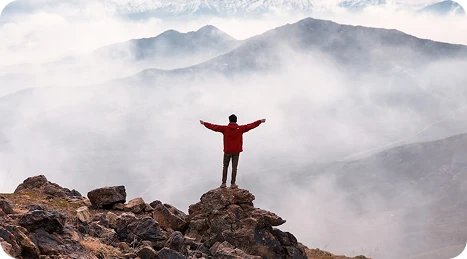 Man standing mountain peak